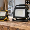 Illustration comparing disconnected rechargeable and mains work lights on a bench