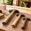 Illustration of claw hammers and eye protection on a workshop bench