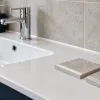 Illustration comparing clear and white sealant samples beside a kitchen sink